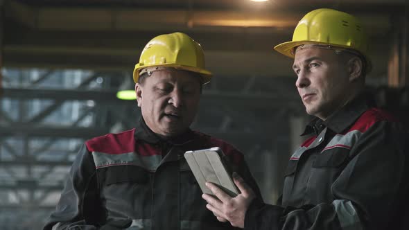 Plant Workers With Tablet Talking