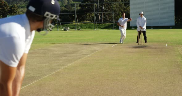 Bowler delivering ball during cricket match