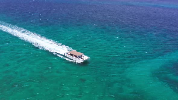 Leisure boat transporting tourists on a day tour in Caribbean; aerial