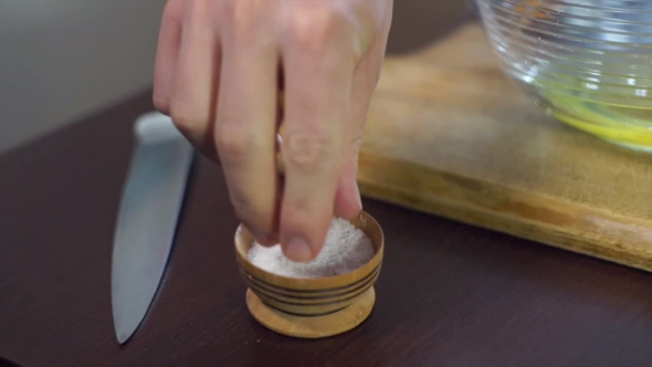 Cook Takes Salt To Salt Dish. Cooking Ingredient