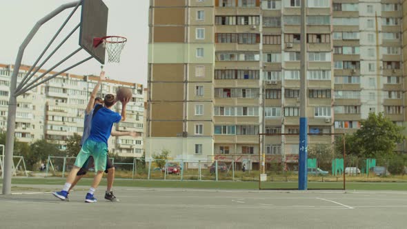 Streetball Player Scoring Field Goal on Court