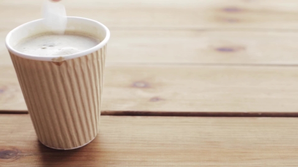 Hand Adding And Stirring Sugar In Cup Of Coffee 72