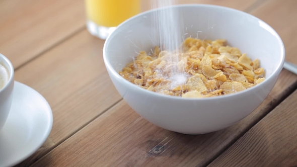 Sugar Pouring To Corn Flakes On Wooden Table 34