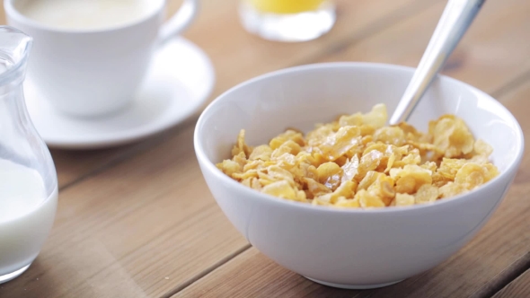 Honey Pouring To Corn Flakes On Wooden Table 40