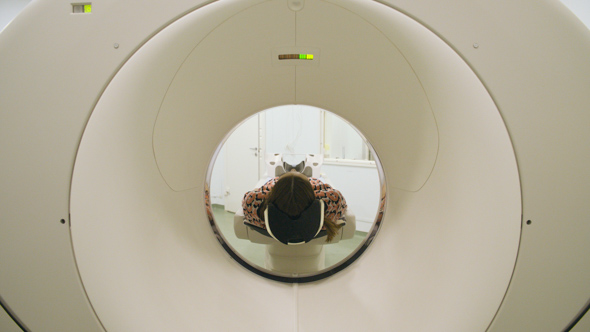 Woman Moving in MRI Machine