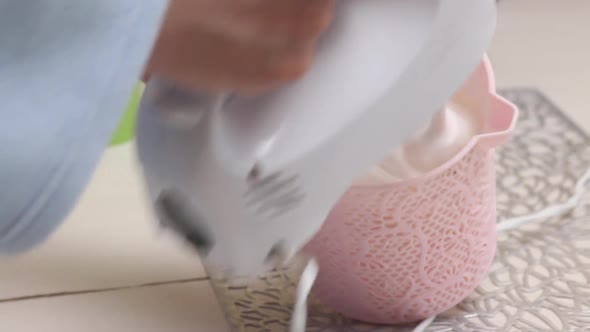 A Woman Prepares A Cream With A Mixer. Cake Count Ruins From Meringue. Close Up