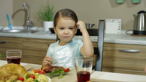 A Little Girl Having Family Dinner