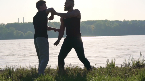 Wing Chun Performance Near The River Between Strong Men