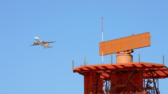 Radar Telecommunications Tower and Airplane Taking Off