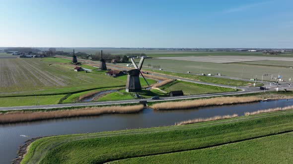 Historic Dutch Windmills in a Farm and Grass Field Landscape in The Netherlands Holland