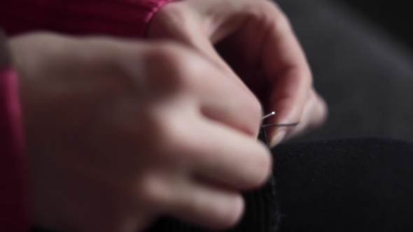 Girl With Needle Manually Sews Their Clothes