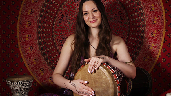 Woman Playing Drum Indoors