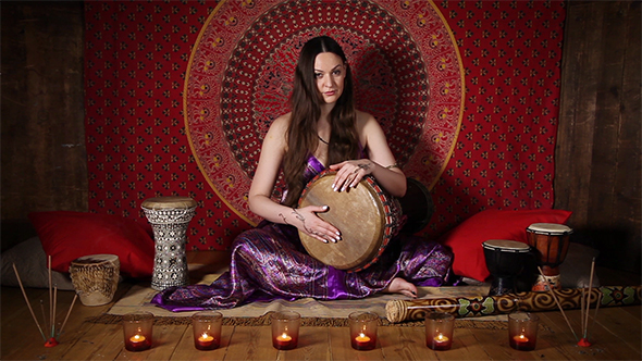 Woman Playing the Drum Indoors