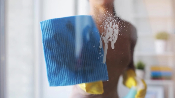 Woman In Gloves Cleaning Window With Rag 55