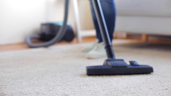 Woman With Vacuum Cleaner Cleaning Carpet At Home 103
