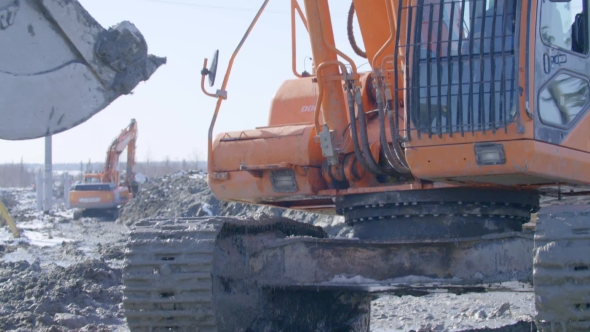 Excavator Moves On a Dirt Offroad