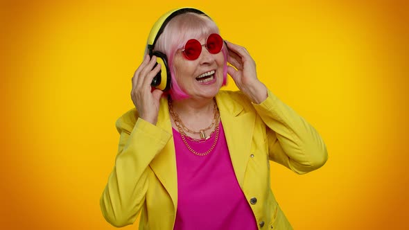 Elderly Woman Listening Music on Headphones Dancing Disco Fooling Having Fun Gesticulating Hands