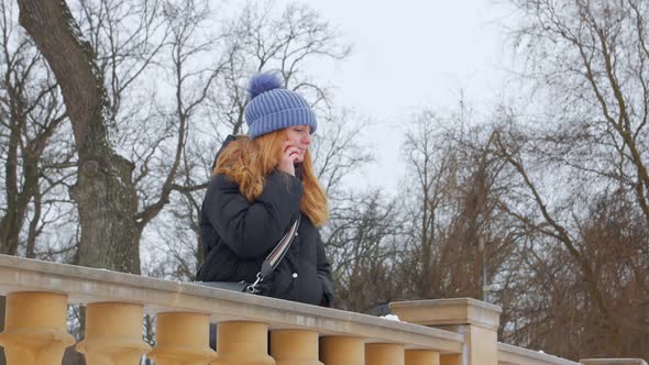 Woman Talking On Smartphone In Winter