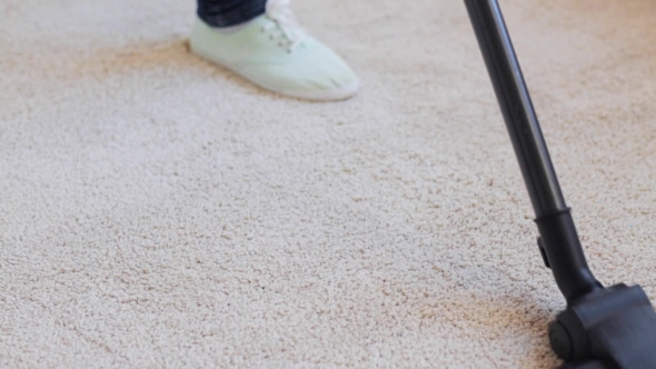Woman With Vacuum Cleaner Cleaning Carpet At Home 41