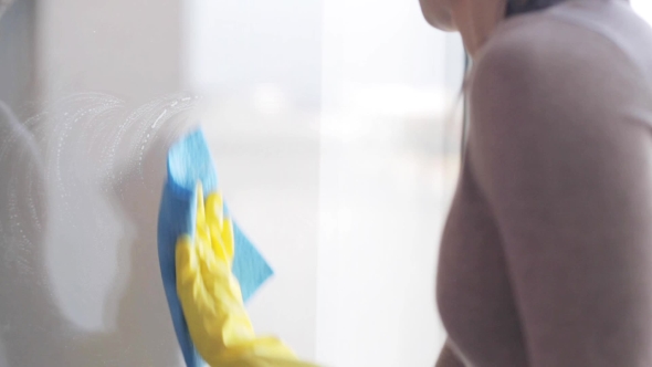 Woman In Gloves Cleaning Window With Rag 10