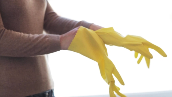 Woman Putting On Rubber Gloves For Housework 28