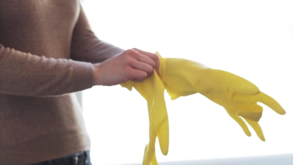 Woman Putting On Rubber Gloves For Housework 27