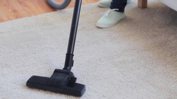 Woman With Vacuum Cleaner Cleaning Carpet At Home 44