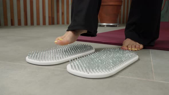 Female Feet Stand on a Sadhu Board with Nails Yoga Practice Standing on Nails Spirituality