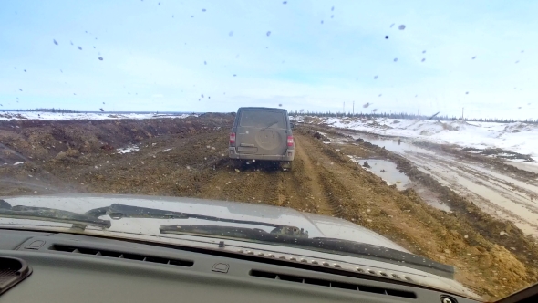 SUV Driving On Dirt Spring Road alt
