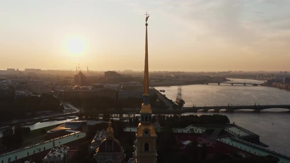 The Drone Flies to the Golden Angel on the Cross of the Peter and Paul Fortress at Sunrise