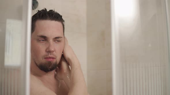 Young Man Is Taking a Shower in Home in Morning Time, Close-up