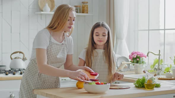 Mother Teaches Teenage Daughter Cook Mom with Little Girl Child Add Red Pepper Ingredients