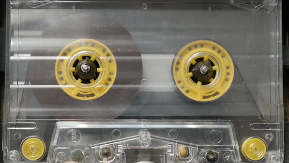 Retro cassette in casettophone close-up 4K 2160p 30fps UltraHD footage - Rotation of audio tape  pla