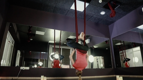 Girl On The Ropes Is Engaged In Yoga