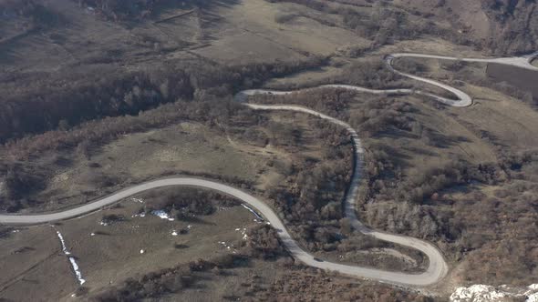 Car going up on the hill serpentine 4K aerial footage