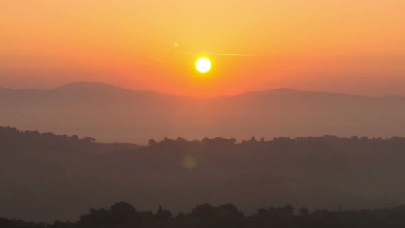 Sunrise Time Lapse Over Hills and Mountains