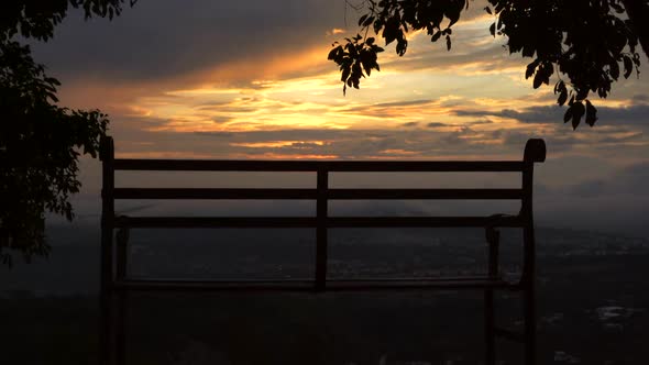 Bench at dawn with sun and clouds in outdoor time lapse beautiful landscape at dusk