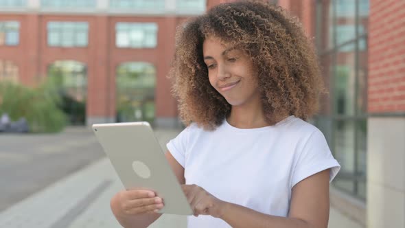 African Woman Browsing Internet on Tablet