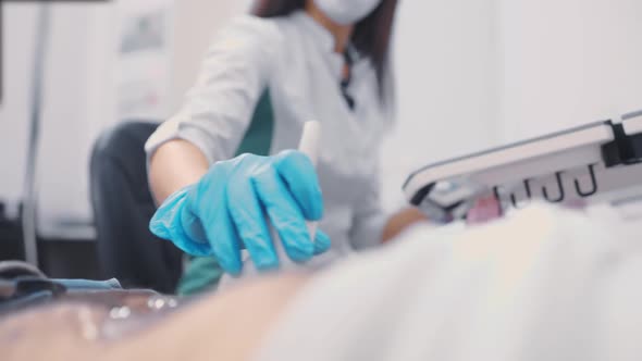 Doctor Doing Abdominal Ultrasound to a Man in a Modern Clinic