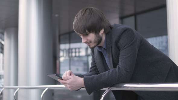 Handsome Hipster Modern Man Using Tablet In The City
