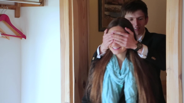 Man Closes Girl's Eyes With His Hands For Surprise
