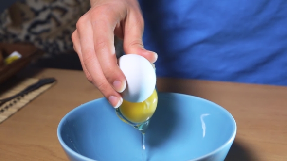 Hand Breaking Egg For Cooking