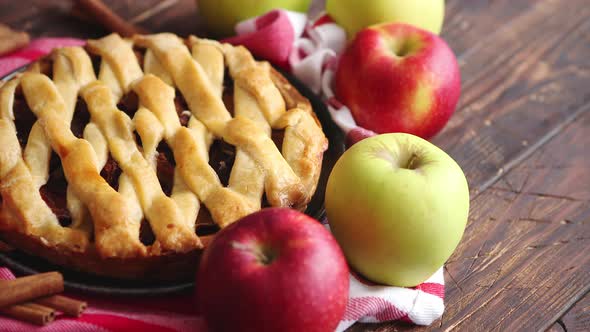 Homemade Pastry Apple Pie with Bakery Products on Dark Wooden Kitchen Table