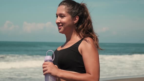 Female Running Along Sandy Ocean Coastline