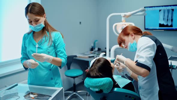 Girl in dental clinic. Woman having teeth examined at dentists