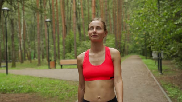 Young Woman Runs Through a Colorful Autumn Forest  She is Doing Her Running Workout Outdoor