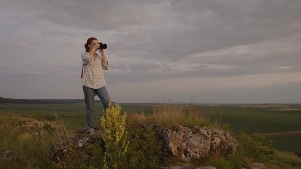 Slow Motion of a Young Girl That Takes Photos of Nature