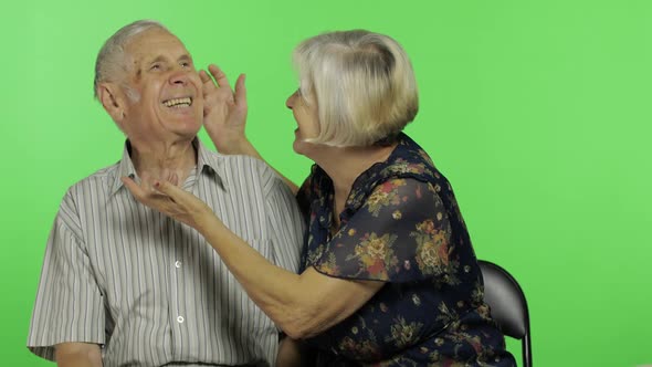 Funny Senior Aged Man and Woman Sitting Together. Concept of a Happy Old Family