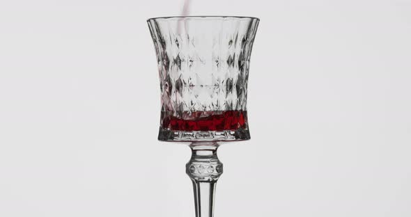 Rose Wine. Red Wine Pour in Wine Glass Over White Background