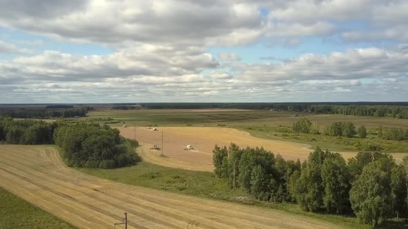 Upper View Modern Harvesters Gather Ripe Wheat on Field